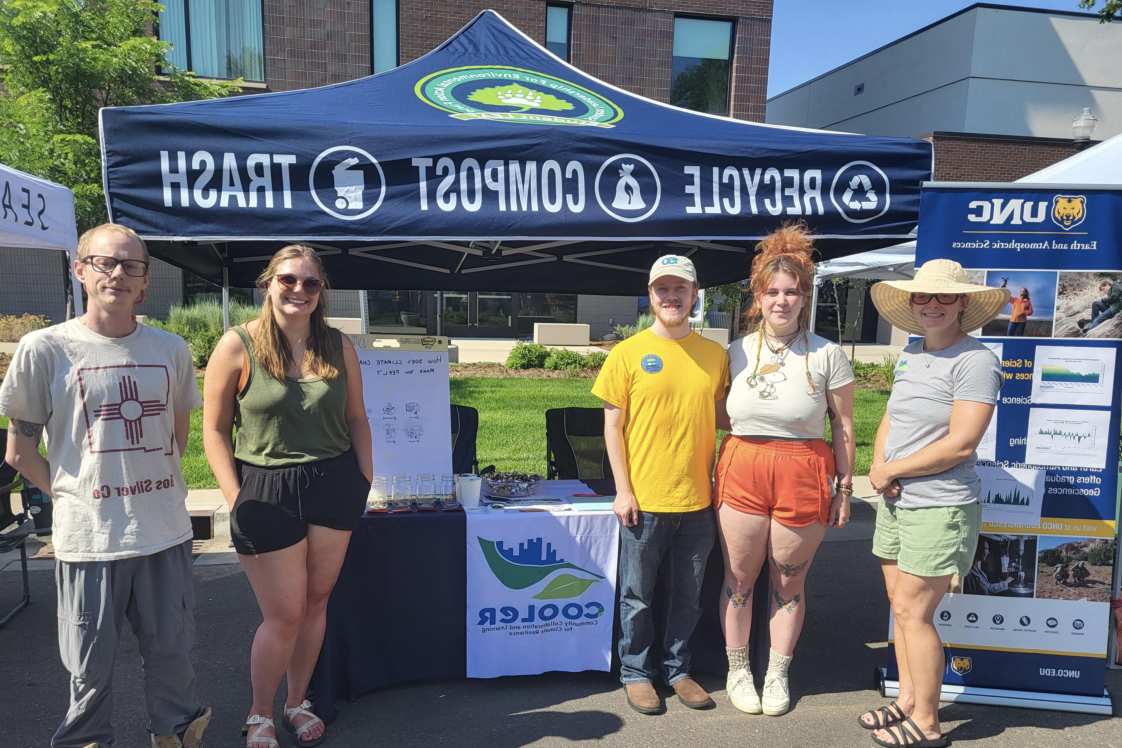 露辛达Shellito, 沙龙Bywater-Reyes, and Chelsea Romulo stand under their tent for the COOLER program.